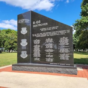 The B-66 Destroyer Memorial is crafted from polished black granite. It features engravings of Air Force seals and memorial information. The memorial is on display at the National Museum of the United States Air Force in Dayton, Ohio.