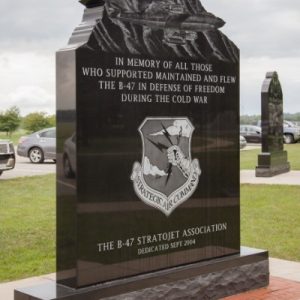 The B-47 Stratojet Memorial honors those who flew and supported the strategic jet bomber. It is crafted from polished black granite and features an engraved image of a B-47 in flight and Strategic Air Command emblem. This memorial is on display at the National Museum of the United States Air Force in Dayton, Ohio.
