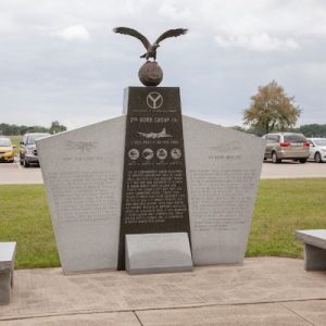 The 2nd Bomber Group Memorial installation consists of 2 benches rendered in grey granite flanking a central, large upright rendered in grey and black granite with a dedication to the members of the 2nd bomber group who served in World War II. The upright is topped with a globe with an eagle with outstretched wings. The 2nd Bomber Group Memorial is located at the National Air Force Museum.