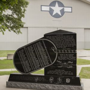 The Reconnaissance Memorial honors the veterans who served in an aerial reconnaissance role during the Vietnam War. A complex and large upright rendered in black granite has a standard rectangular aspect connected to a dogtag shaped area with the names of those honored are engraved. The monument features engraved images of the aircraft used in the mission. The Reconnaissance Memorial is located at the National Air Force Museum.