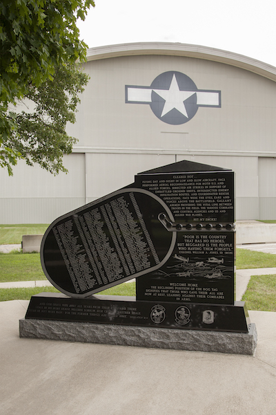 The Reconnaissance Memorial honors the veterans who served in an aerial reconnaissance role during the Vietnam War. A complex and large upright rendered in black granite has a standard rectangular aspect connected to a dogtag shaped area with the names of those honored are engraved. The monument features engraved images of the aircraft used in the mission. The Reconnaissance Memorial is located at the National Air Force Museum.