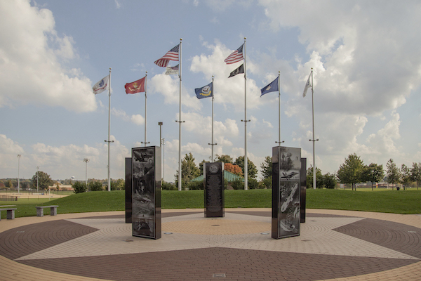 The Kettering Delco Park Veterans Memorial Plaza is crafted from polished black granite. It features 5 uprights with laser engraving of images and memorial information. It is on display in Kettering, Ohio.