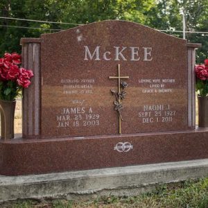 This Companion Upright honoring McKee is crafted from polished red granite and bronze and is flanked by two vases. It features a bronze sculpture with climbing roses. This memorial is suitable for use with traditional interment or cremation.