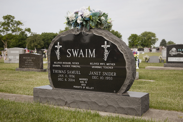 This Custom Companion Upright honoring Swaim is rendered in black granite in an ovoid shape with a rough finish all around. The face is polished and features a dedication as well as twin crosses. It is located at Byron Cemetery in Fairborn, OH. This memorial is suitable for use with cremation or traditional interment.