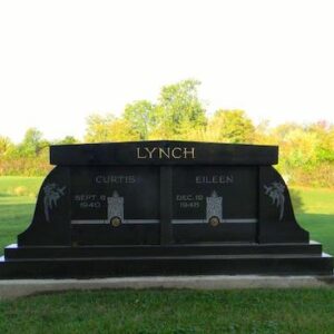 The Lynch Family Mausoleum is crafted from polished black granite. It features engravings and a large two part upright on placed atop a step pedestal. This memorial is appropriate for use with cremation or traditional interment.