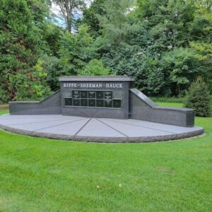 This Rippe Cremation Family Estate Memorial. is a family estate monument with a wide, arched granite platform, and large plinth for honoring multiple people. It is crafted from Rock of Ages Laurentian Green Granite and is located at Spring Grove Cemetery in Cincinnati, Ohio.