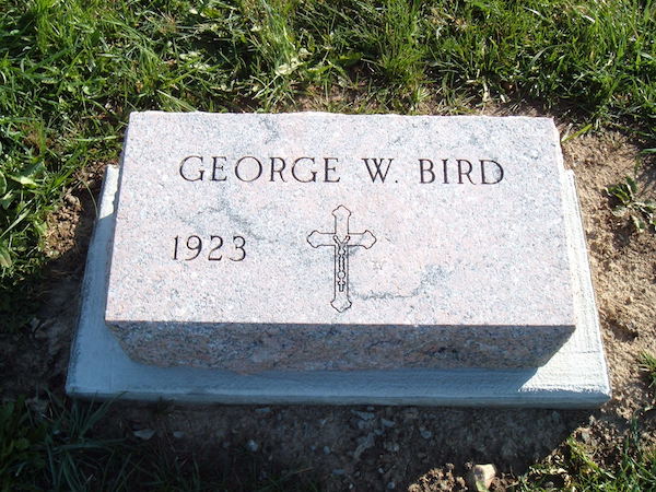 This Flat Marker honoring Bird is a flat monument rendered in white granite featuring an engraved cross. It is suitable for use with traditional interment or cremation.