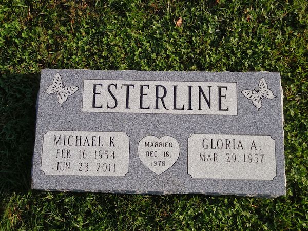 This Companion Flush Marker honoring Esterline is crafted from Rock of Ages gray granite. It features engravings of butterflies and a heart. This memorial is suitable for use with traditional interment or cremation.