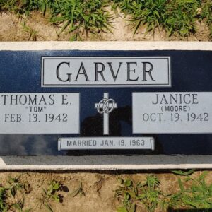 This Companion Flush Marker honoring Garver is crafted from polished black granite. It features an engraving of a cross and two entangled rings. This memorial is suitable for use with traditional interment or cremation.