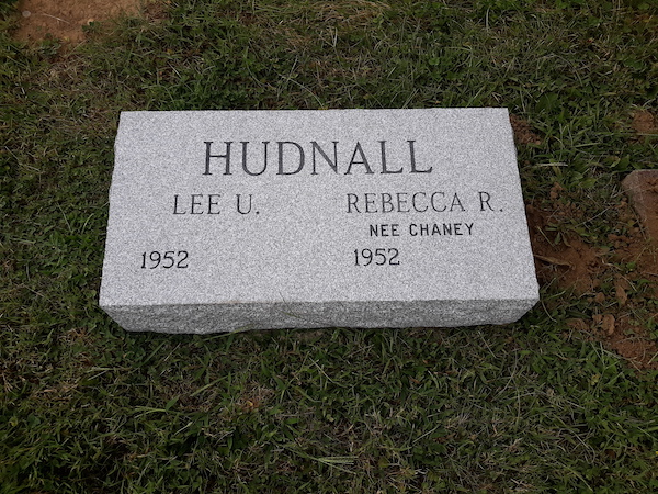 This Companion Bevel Marker honoring Hudnall is crafted from gray granite. It is suitable for use with traditional interment or cremation.