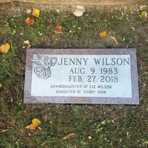 This Single Flush Marker honoring Wilson is crafted from pink granite. It features an engraving of an angel holding a heart. This memorial is suitable for use with cremation or traditional interment.