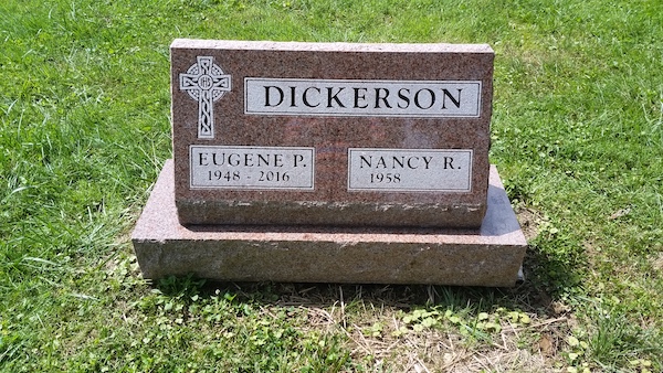 This Companion Slant Memorial honoring Dickerson is crafted from red granite. It features an included base and an engraved Celtic cross. This memorial is suitable for cremation or traditional interment.