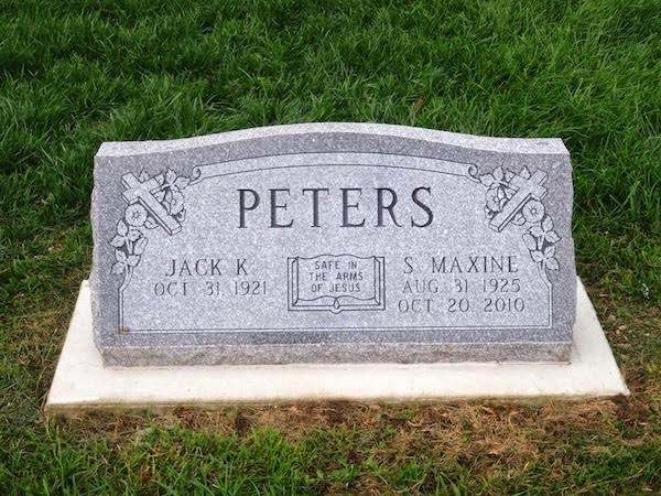 This Companion Slant Marker honoring Peters is crafted from gray granite. It features engravings of two crosses and an open bible. This memorial is suitable for use with traditional interment or cremation.