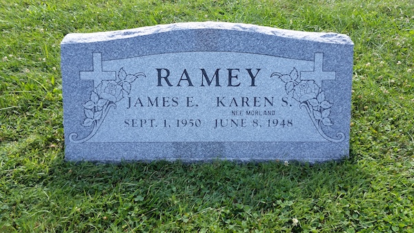 This Companion Slant Marker honoring Ramey is crafted from gray granite. It features two engraved crosses with floral accents. This memorial is suitable for use with traditional interment or cremation.