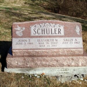 This Companion Slant Marker on a Base honoring Schuler is crafted from pink granite. If features engravings of a butterfly, angel, and floral scroll work. This memorial is suitable for use with cremation or traditional interment.