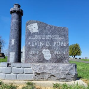 This Custom Single Upright with Lighthouse is crafted from Coral Blue granite. It is in the shape of a lighthouse and is located at Silvercreek Cemetery New in Jamestown, Ohio. This memorial is suitable for use with cremation or traditional interment.