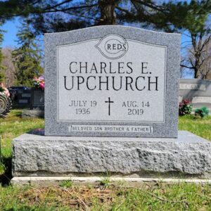 This Single Upright with Cincinnati Reds Logo is a standard monument with an engraved Cincinnati Reds logo and cross. It is crafted from Barre Granite from Rock of Ages. This memorial is located at Woodland Cemetery in Xenia, Ohio. This memorial is appropriate for use with traditional interment or cremation.