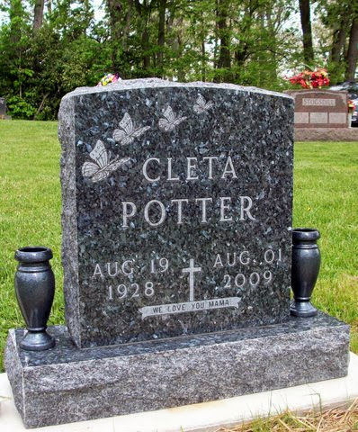This Single Upright with Butterflies and a cross is crafted from blue granite, flanked by two vases, and installed on a base. This memorial is appropriate for use with traditional interment or cremation.