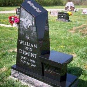 This Custom Single Upright with Bench memorial is crafted from an irregular polished black granite stone and features a photo realistic laser engraving of the decedent. This memorial is appropriate for use with traditional interment or cremation.