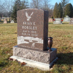 This Single Upright in Red Granite features an engraving of an outdoor scene featuring an eagle, a lake, and a fisherman in a boat. This memorial can be used in a cremation scenario or with traditional interment.