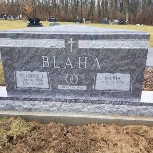 This Companion Upright carved with Cross and Rings is crafted from coral blue memorial for the Blaha family. It features a custom carved border, cross, and wedding rings. It is located at Springboro Cemetery in Springboro, Ohio and is suitable for traditional interment or cremation.