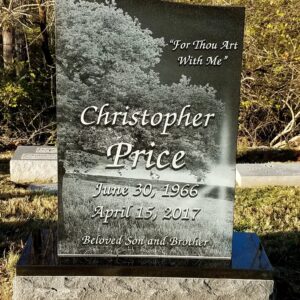 This memorial is a Single Upright with Laser Engraved Tree. Crafted from polished black granite, it features a photo realistic image of a tree in a nature setting with the decedent's memorial information. This monument is appropriate for use with traditional interment or cremation.