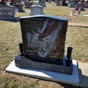 This Single Upright with Laser Engraved Eagle and Flag is crafted from black polished granite and features a photo realistic laser engraving. This memorial is appropriate for cremation or traditional interment.