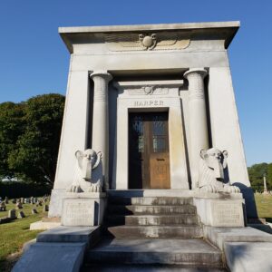 The Historic George Harper Mausoleum is crafted from gray granite and features a pair of sphinx sculptures guarding the vault.