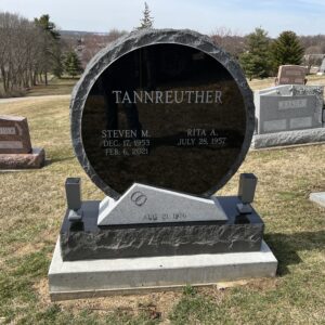 This Disc Custom Companion Upright memorial was crafted from black supreme and Newberry gray granite for the Tannreuther family. It is located at Mound Cemetery in Monroe, Ohio. It is suitable for use with cremation or traditional interment.