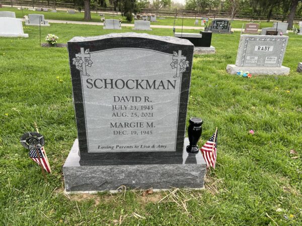 This Companion Upright with Dual Cross Carvings memorial with stacked names was crafted from Rock of Ages Black Mist granite for the Schockman family. It is located at Evergreen Cemetery in Miamiville, Ohio. It is suitable for use with cremation or traditional interment.