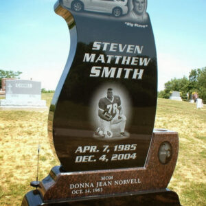 This Custom Single Upright in Two-tone Granite; the lower section is crafted from red granite and the upper section is crafted from polished black granite. The upper section features laser engraved, photo realistic images of the decedent and a car. The lower section features a laser engraved image of the decedent and his mother. This memorial is suitable for use with cremation or traditional interment.