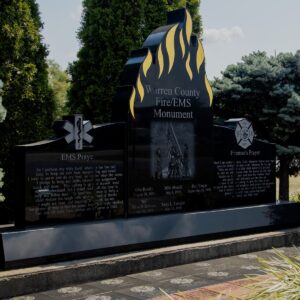 The Warren County Fire and EMS Memorial is crafted from polished black granite in three components. The central component is shaped to accommmodate bright yellow flames at the top of the stone and features a laser engraved image of an emergency response and contains the memorial information. The two flanking components have carvings of the Fireman's cross and EMS caduceus along with prayers for each. You can see this memorial in person in Lebanon, Ohio.