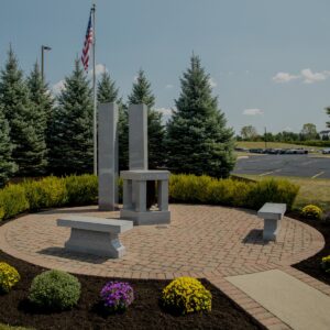 The Warren County 9/11 Memorial is crafted from polished gray granite. It features two blocks shaped like the twin towers of the World Trade Center in New York before the attack. It also has two benches and a central shrine with memorial information. You can see this memorial in person in Lebanon, Ohio.