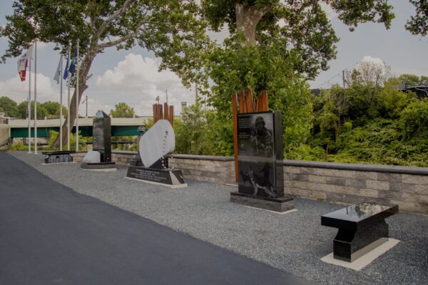 The Springfield Veterans Memorial Park is crafted from gray and polished black granite. It consists of 2 benches and 3 uprights. One of the uprights is shaped to resemble a dog tag. All of the components feature memorial information and engravings.