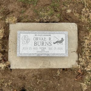 This single flush marker with mushrooms is crafted from gray granite and features carvings of a fisherman and mushrooms. This memorial is suitable for cremation or traditional interment.