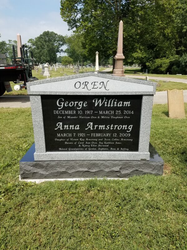 This companion upright memorial created from Black Ultimate, Newbury Gray granite is placed Greenlawn cemetery. It is appropriate for one or multiple people who have been cremated and interred.